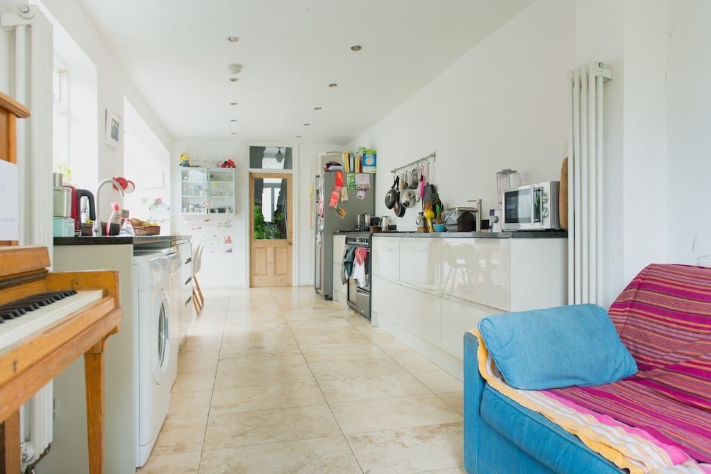 Piano and seating area also in kitchen