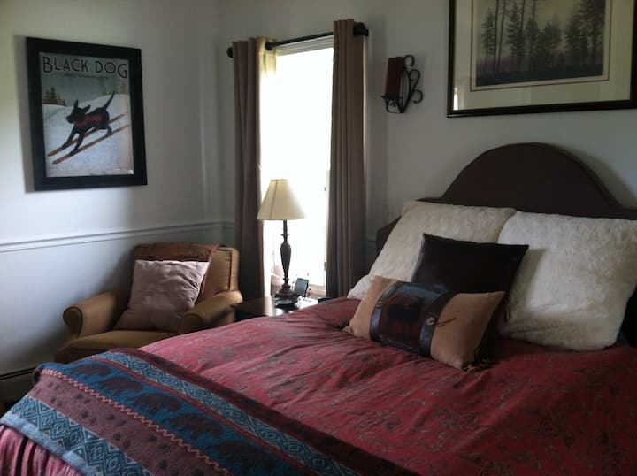 Master bedroom with full bath and ceiling fan.