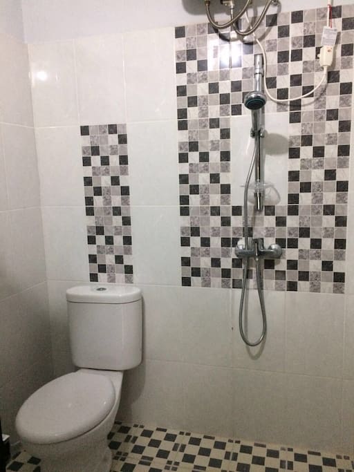Shower and toilet adjacent to the kitchenette; hot and cold water