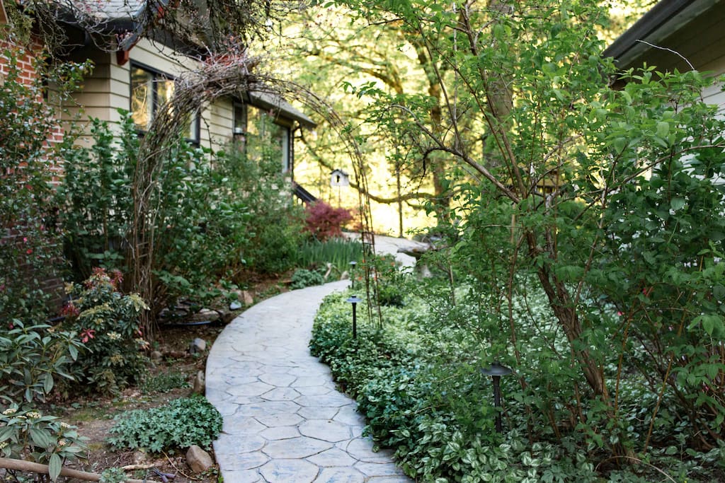 From the driveway, take the lush garden path leading to the back of the house to access the guest entrance. You are welcome to explore and utilize the yard.