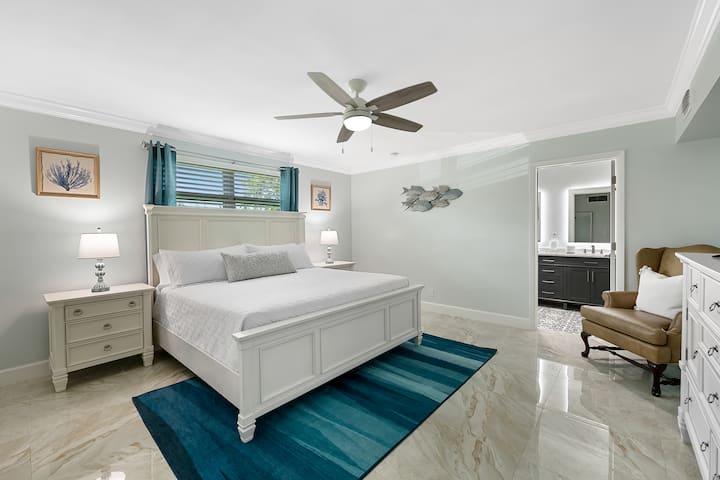 peaceful, large master suite with king sized bed featuring a super comfy memory foam mattress, and usb charging touch lamps