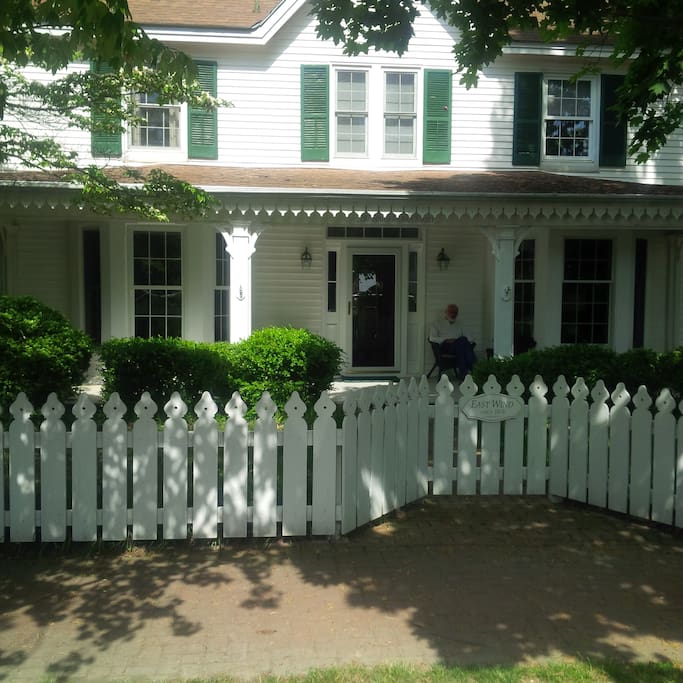 Lots of curb appeal and a wonderful front porch to enjoy gin and tonics and catch a sliver of a water view as you watch the sunset