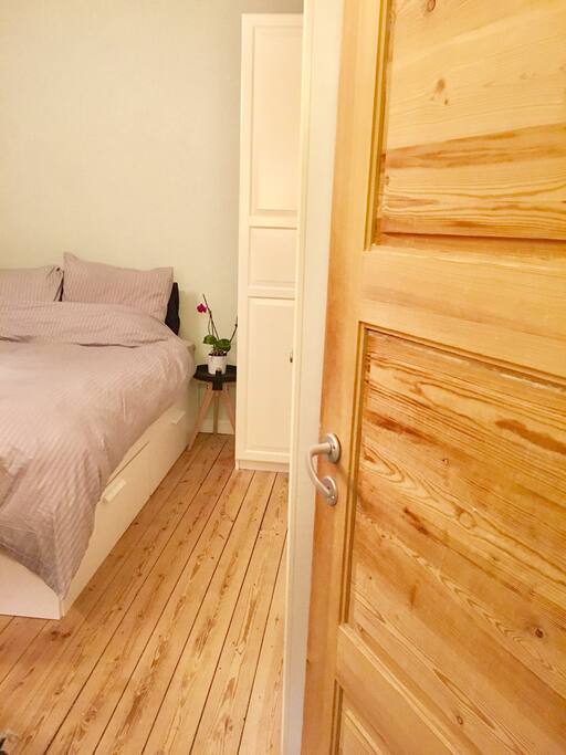 Bedroom from hallway - Big bed - notice the old original wooden planks