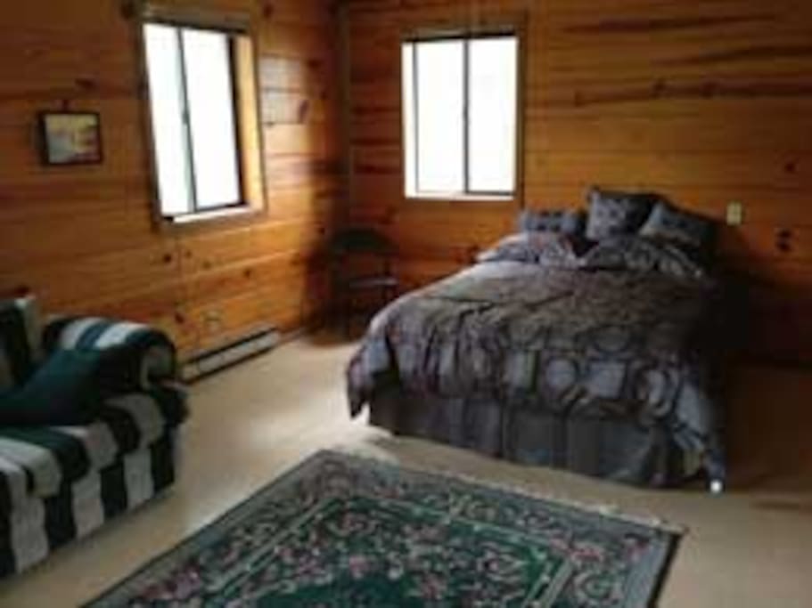 Queen bed, sofa, and dining table