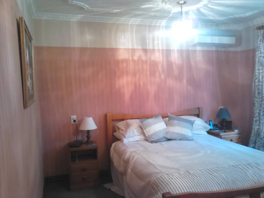 Bedroom with air conditioner. And queen bed.