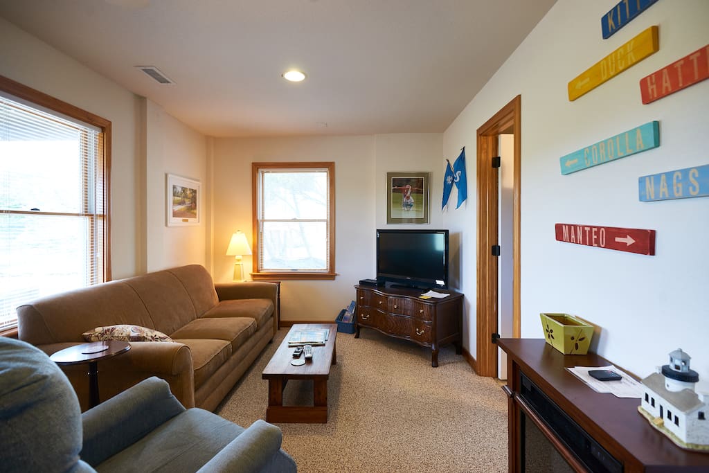 Living area with couch, recliner, futon, and tv.