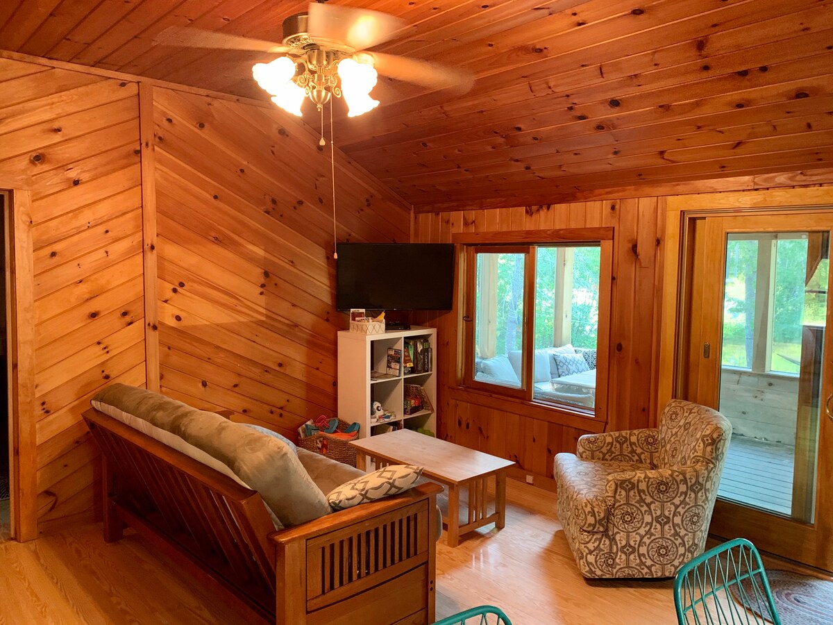 The living room with futon/couch that folds down into a full sized bed