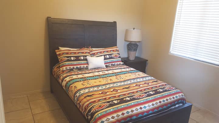 Middle guest bedroom - Queen size bed with chest of drawers, under-bed drawers, night stand, and 50 inch TV with Xfinity via Roku