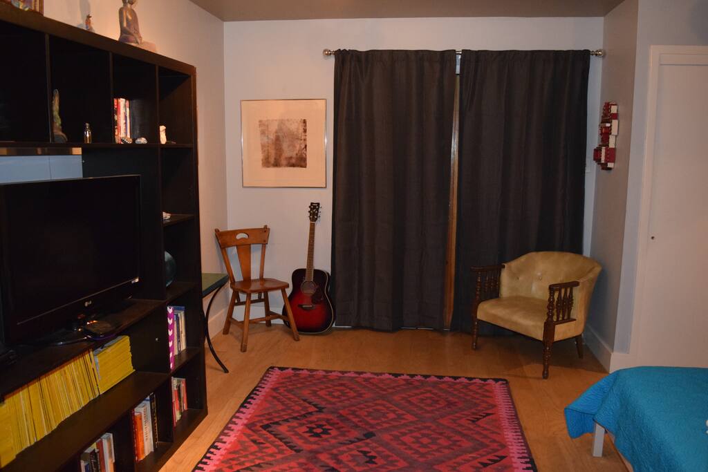 Living room/bedroom. Cozy environment, and the black out curtains make for a good night's sleep!
