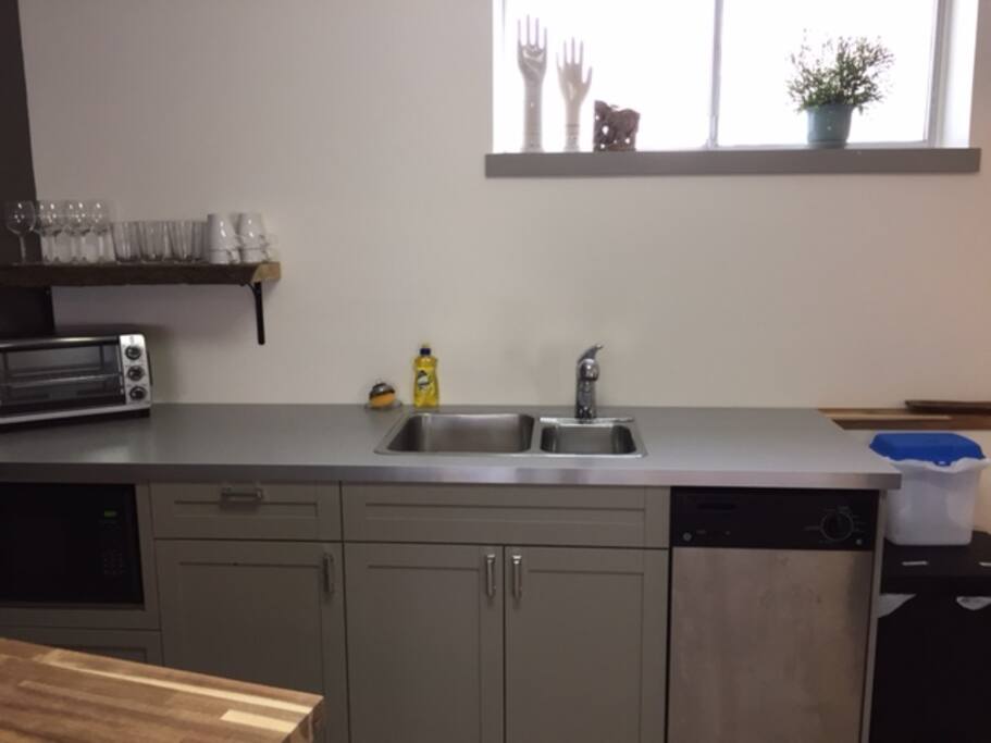 The kitchenette has a microwave, toaster oven, dishwasher, kettle and fridge.
