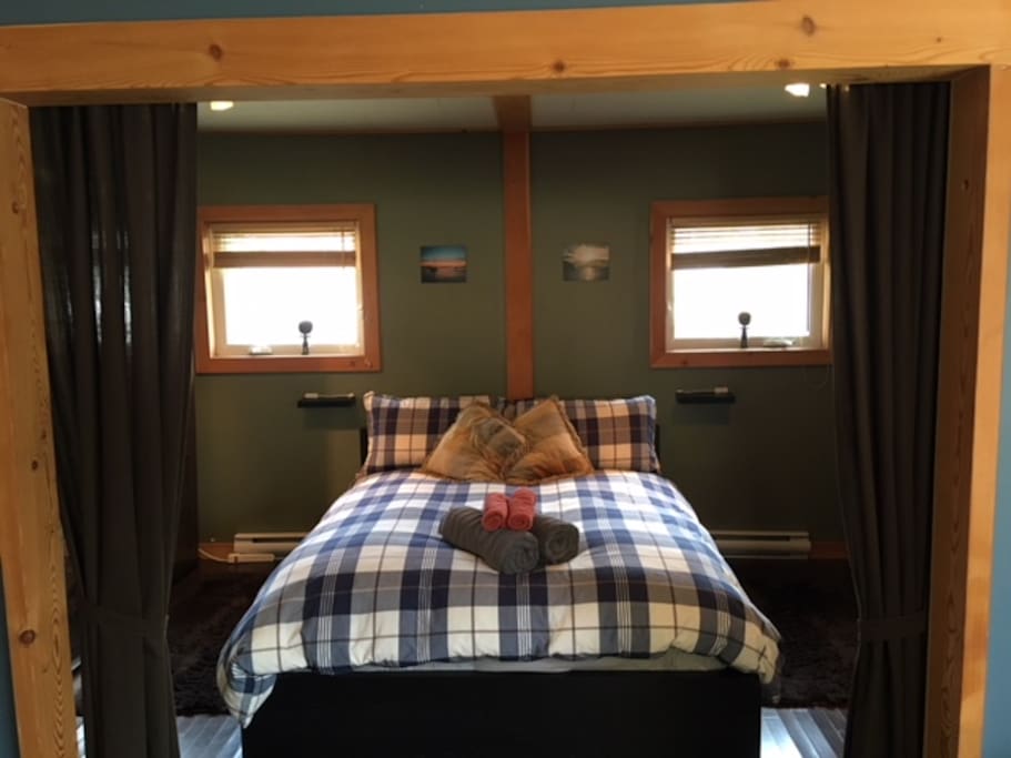Comfy bed with warm duvet cover and many pillows.