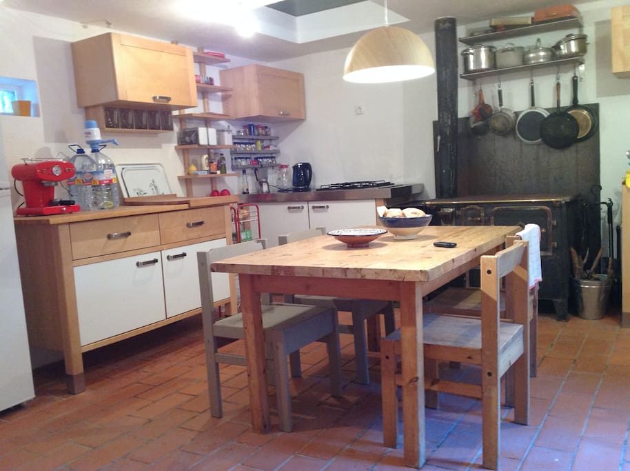 fully equiped kitchen and living room with traditional oven and cookingequipment.