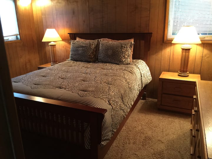Queen size bed in downstairs bedroom. 