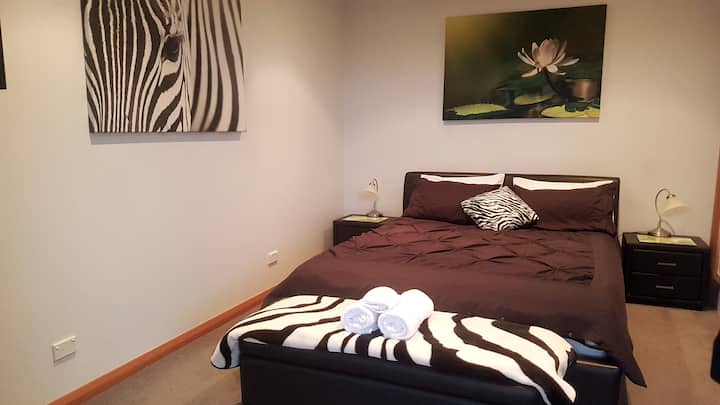 Luxurious queen bed fitted with electric blankets.