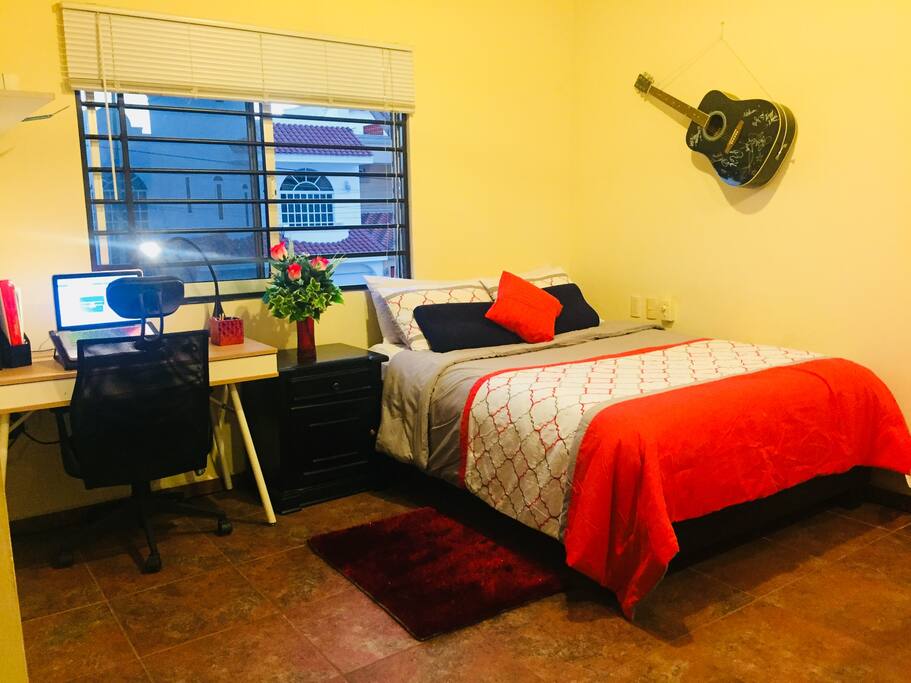 Bedroom: Comfy queen size bed with side table, desk table, office chair, 3 setting classy office/side light