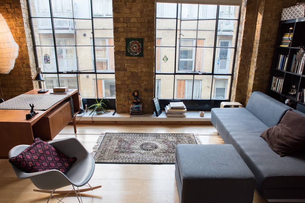 Bright spacious room with a piano in a stylish conversion