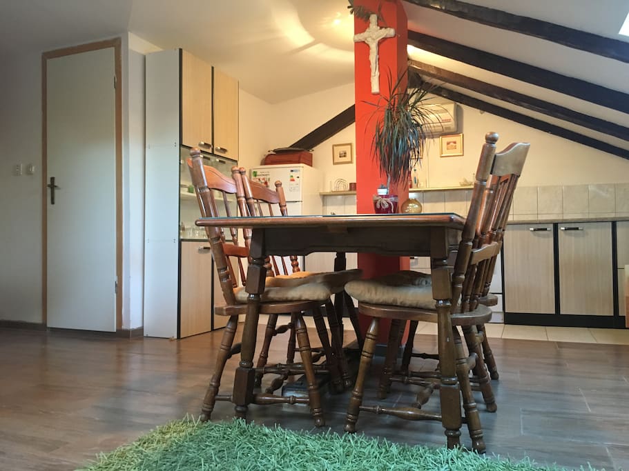 The living room with the table nd chairs. Kitchen in the background