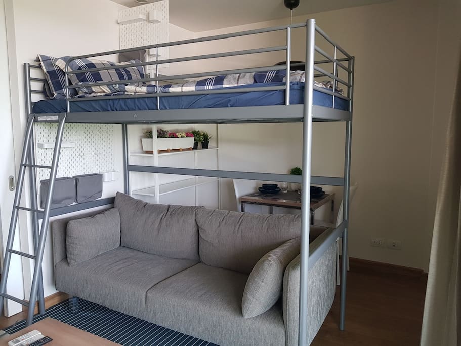Bunk bed set with private wall storage and sofa underneath