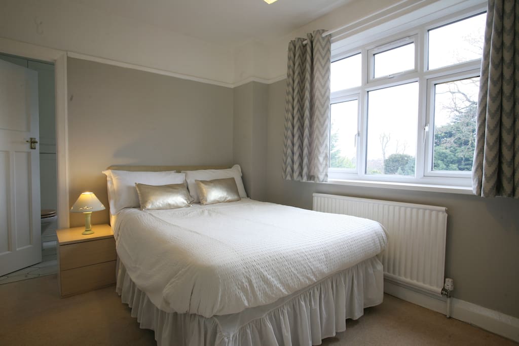Double room with en suite bathroom and view of garden and cricket ground