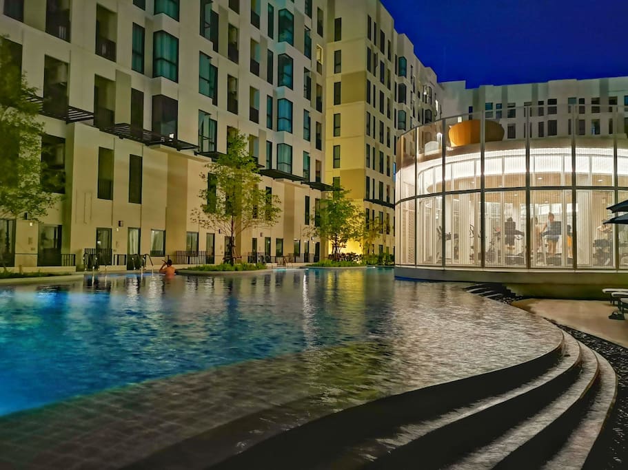 Swimming pool at night (Guest cannot use the fitness and library, unless stay for more than 1 month)