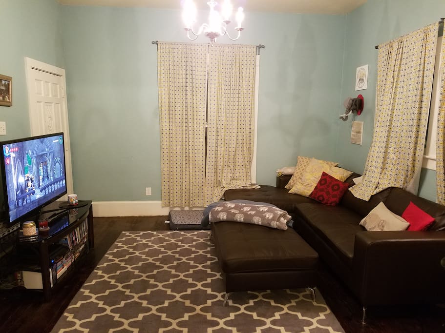 Comfy living room with big soft couch, dvd collection, board games, PS3, Wii and cable/DVR