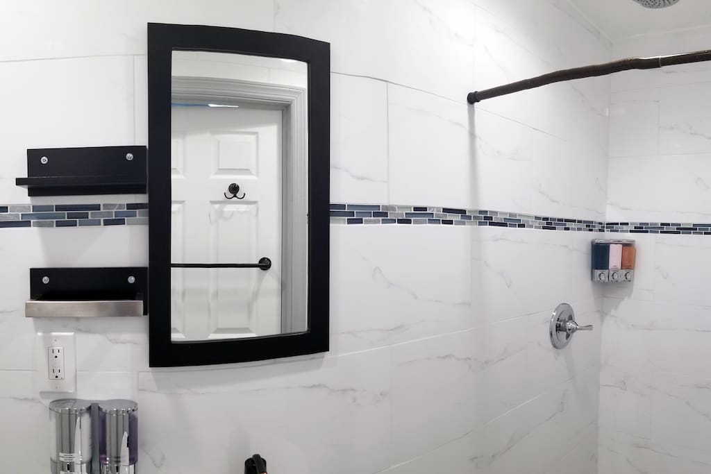 Stylish contemporary bathroom with chrome toiletry dispensers