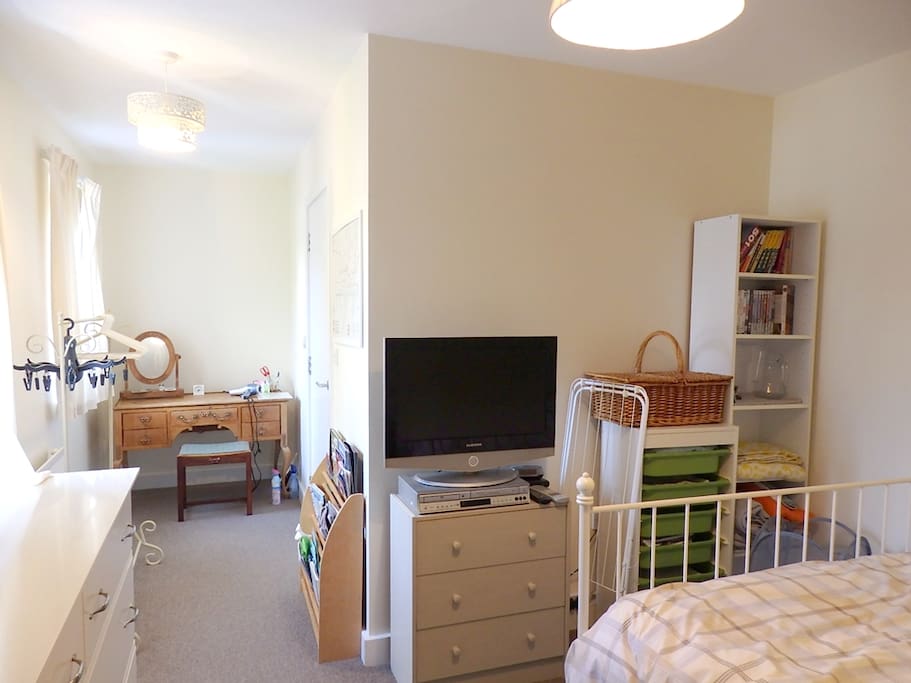 TV, DVD player, Dressing table, Clothes rail.