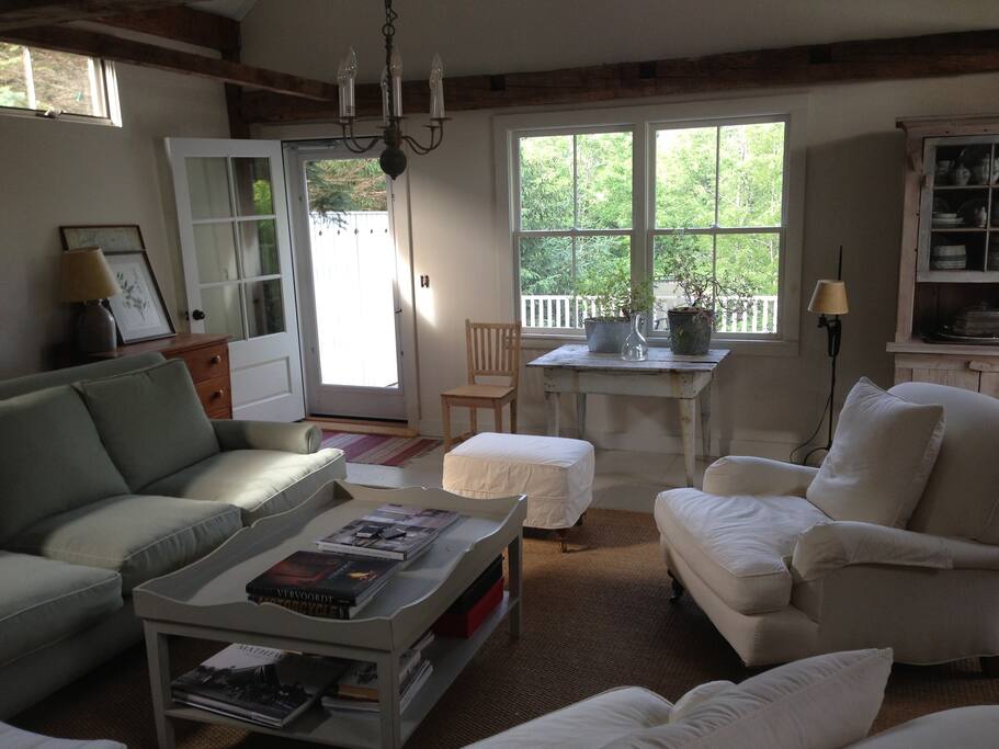 The living room. The large deck is accessible from the living room, and overlooks a brook.