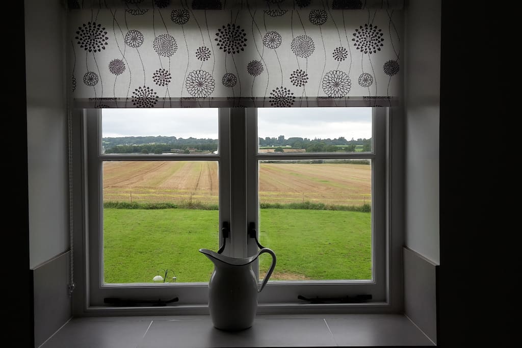 Large modern en-suite bathroom with lovey views