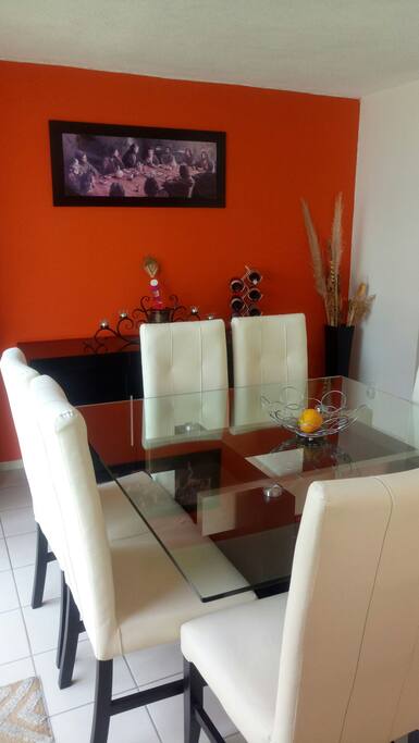 Comedor con mesa de cristal para 8 personas.