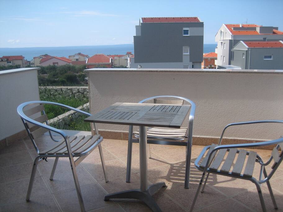 Large balcony with table and chairs.