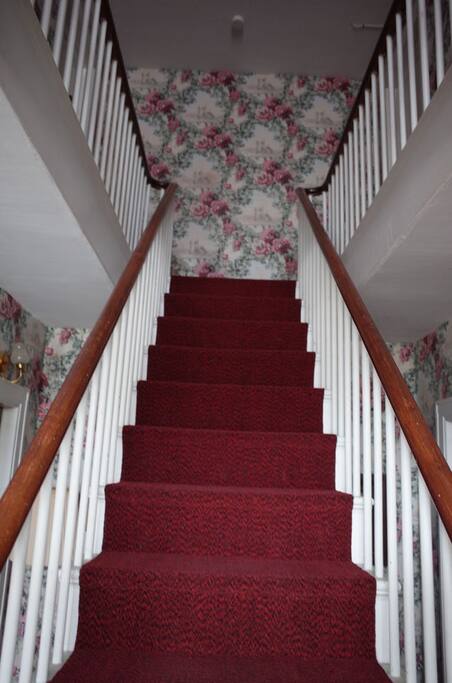 Front hall stairway leading to your suite