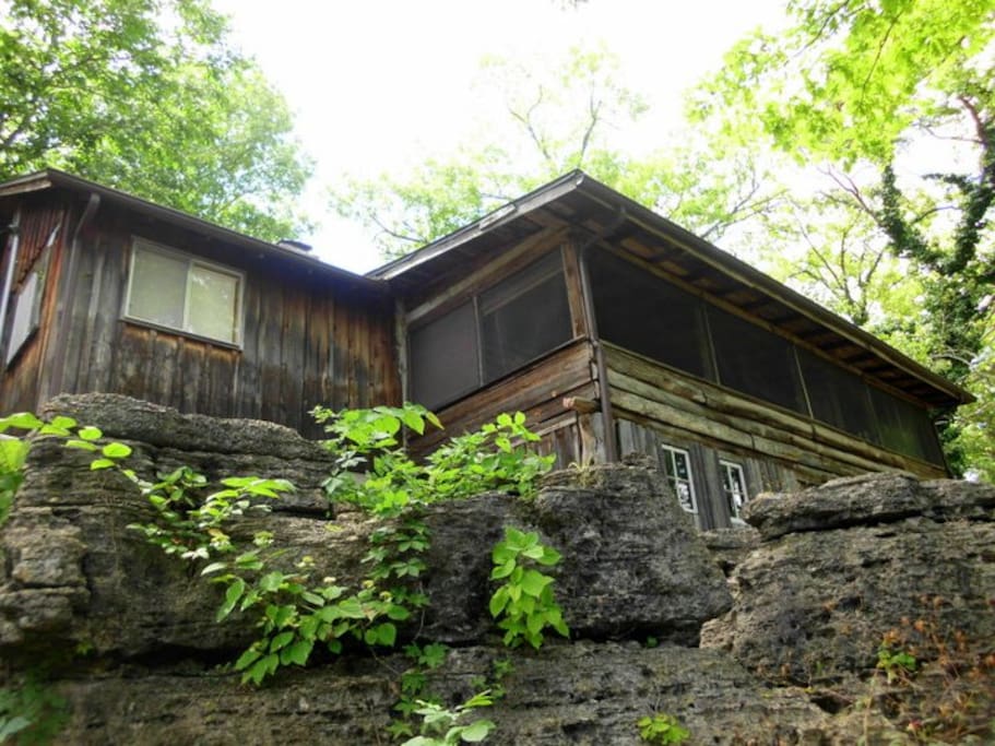 Cabin is perched on large rock outcropping overlooking the lake.