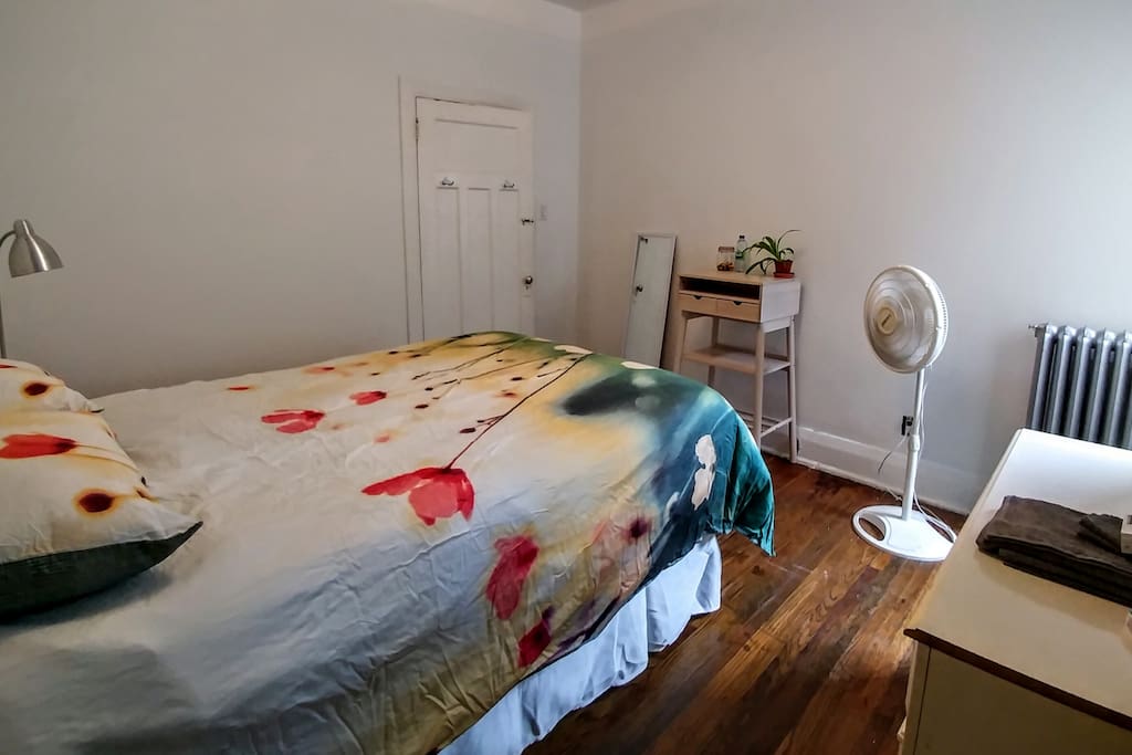 The bright, white bedroom comes complete with a fan, standing desk, dresser, in-room closet & night table -- everything you need for a comfortable stay. Toiletries are provided for short term stays.