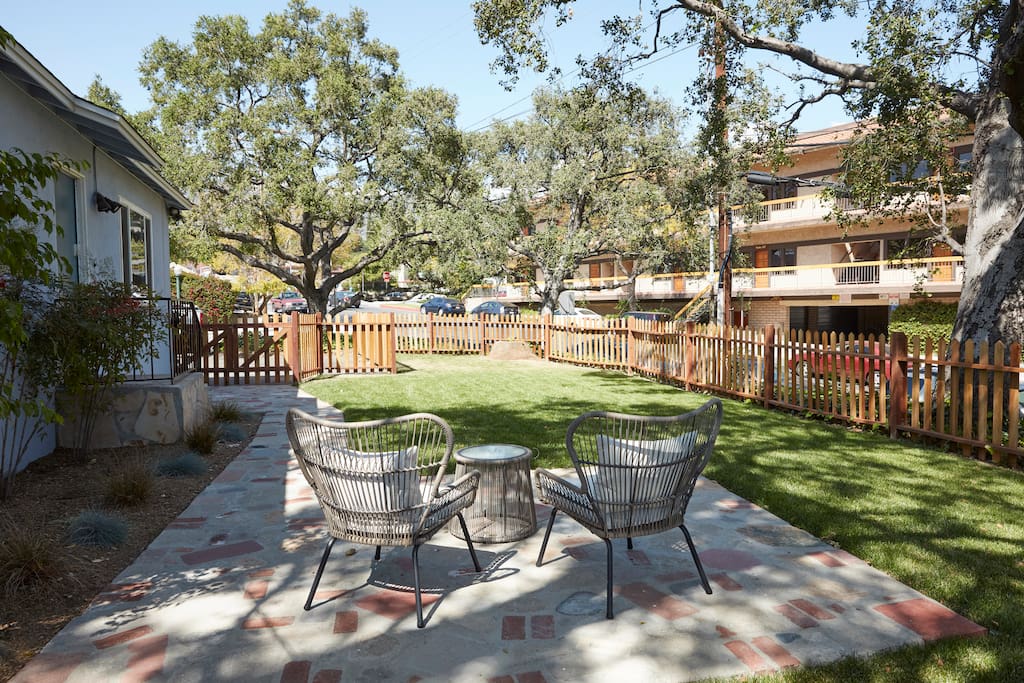 Front yard patio and fenced in lawn area