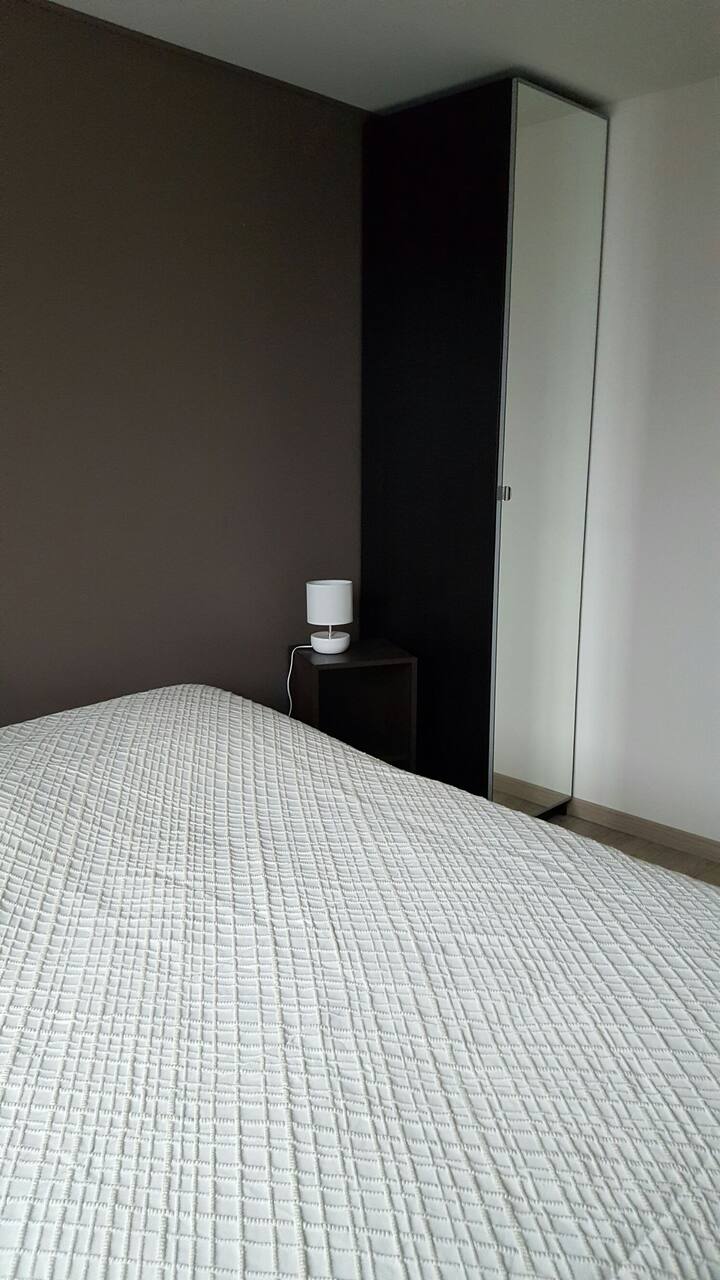Chambre avec un lit double de 140 cm. Une colone armoire facilite le rangement avec des cintres. 