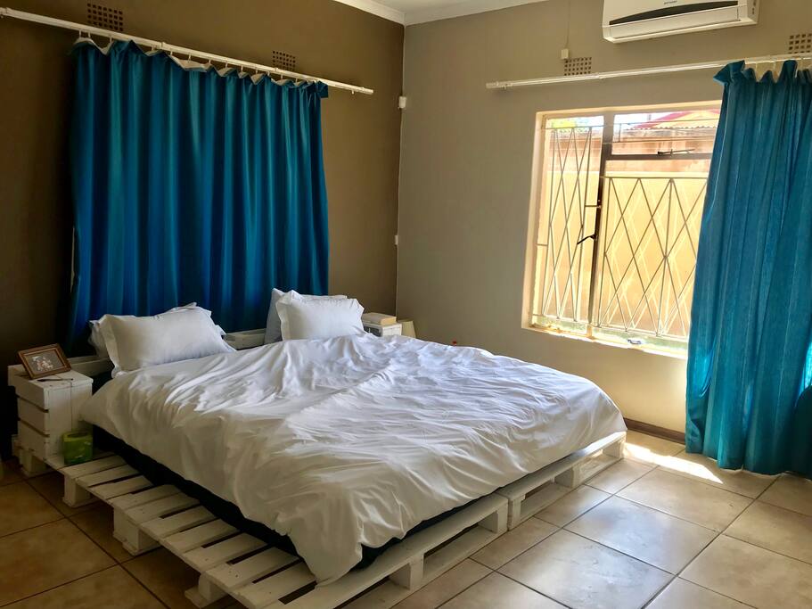 King size bed, ensuite bathroom and air conditioner in this room.
