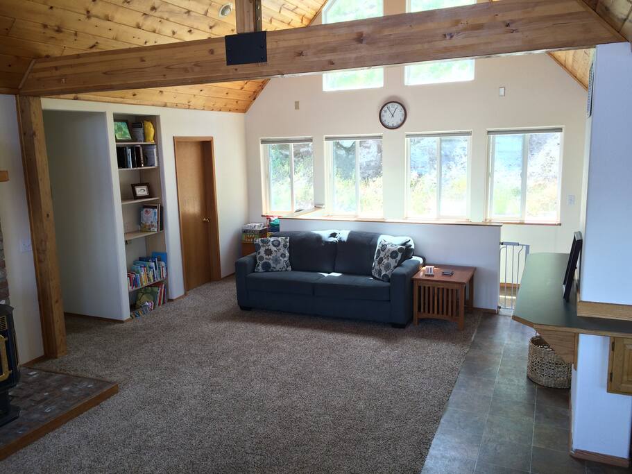 Main living room with hill side view out the back. Lots of natural light too!