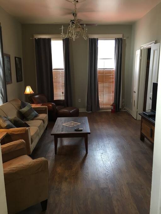 Living room has 2 windows overlooking Magazine St.