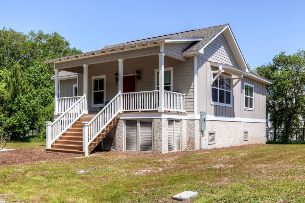 This house sits on a large lot surrounded by marshland, lush trees, and beautiful views.