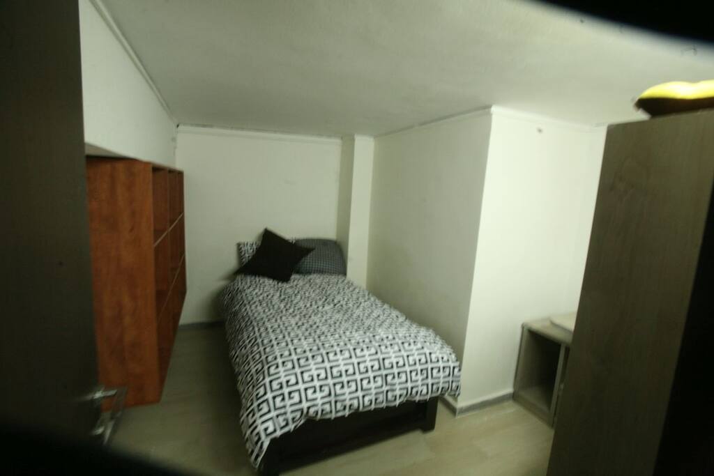 a double bed with a small office space