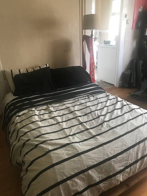 Full-size bed with extra pillows and extra blankets