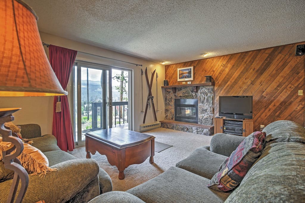Relax in the living room with a fireplace and flat screen cable TV.