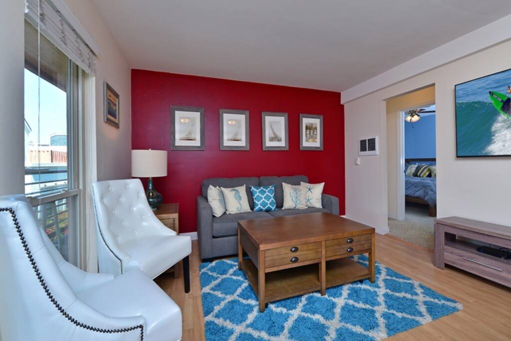 Living room with 60" television, DirecTV and queen sofa sleeper