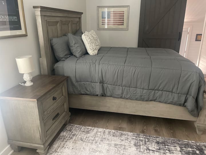 Queen size bed with extra pillows.