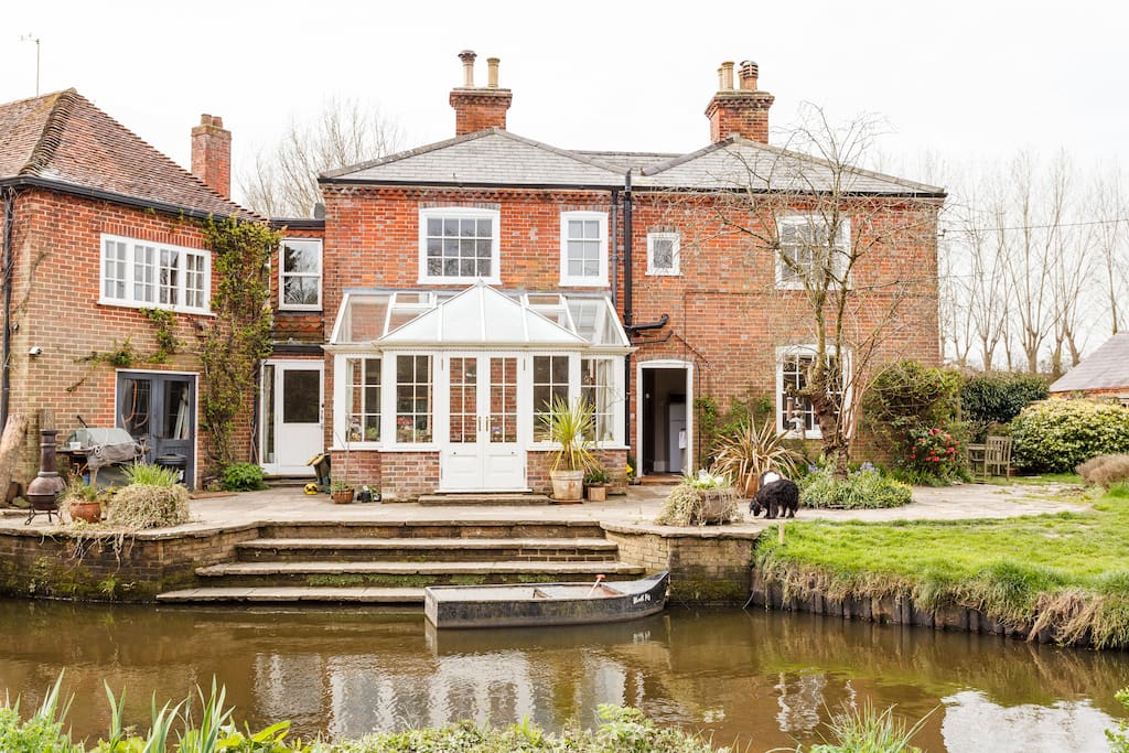 View of house from across the river. The accommodation that we rent out is on the right of the conservatory