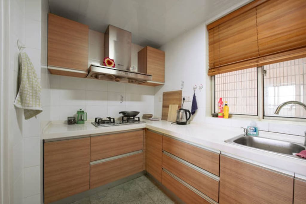 Kitchen with microwave, pots and pans, and refigerator/freezer.