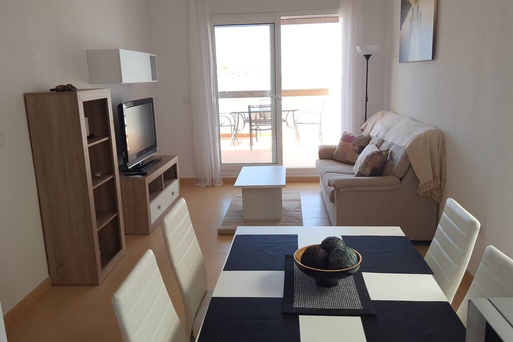 Main living space with patio doors leading to the large balcony