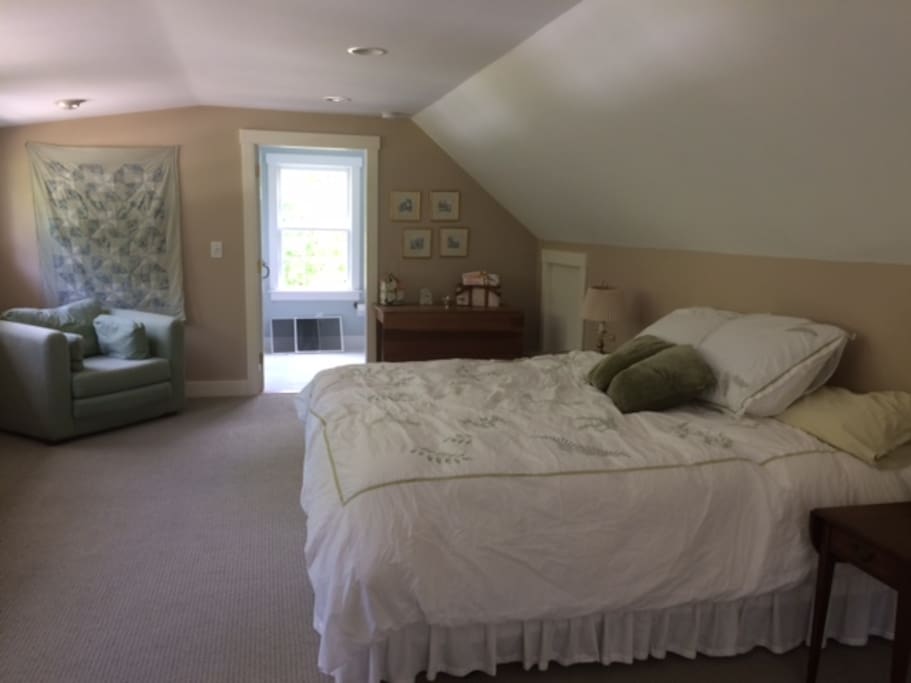 Large bedroom with king size bed, and large chair that folds out to a mattress on the floor. Great for kids.
