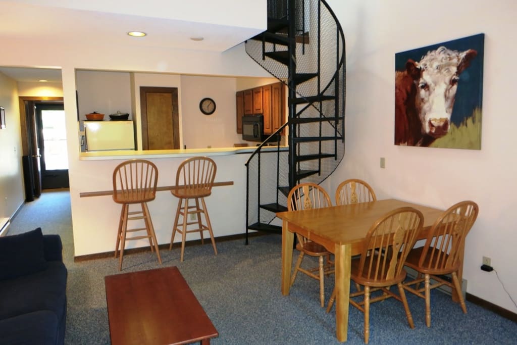 Bar seating beside kitchen. Table includes extra leaf and chairs to seat 8.